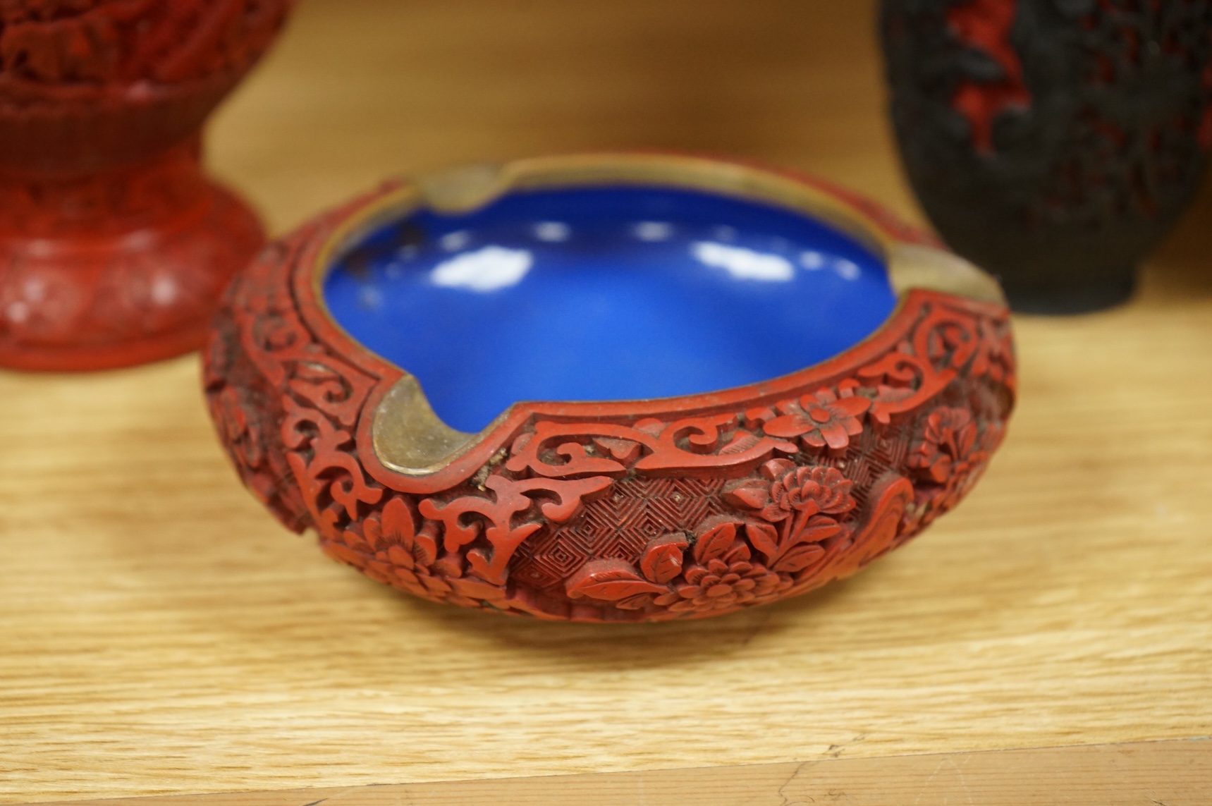 Two Chinese cinnabar lacquer vases and an ashtray, largest 20cm high